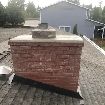 Chimney cap and flue rebuild project on a rooftop in Marysville, WA