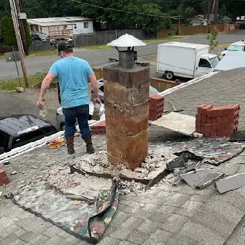Rooftop chimney masonry repair in progress in Seattle, WA.